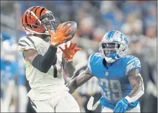  ?? PAUL SANCYA – THE ASSOCIATED PRESS ?? Ja’Marr Chase, left, the fifth overall pick in the 2021 draft out of LSU, has provided a spark for the Bengals offense with 27 catches, including five TDs.