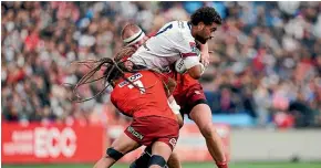  ?? GETTY IMAGES ?? Reds forward Lukhan Salakaia-Loto takes on the defence.