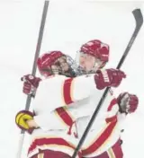  ??  ?? DU’s Troy Terry, left, and Logan O’Connor celebrate after O’Connor scored in the second period Friday. Andy Colwell, Special to The Denver Post