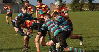  ??  ?? Niall O’Connor drives through a tackle.