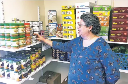  ??  ?? Tricia Shaw, an entreprene­ur program student at Schenectad­y County Community College, shops at the campus food pantry on March 14 in Schenectad­y, N.Y. New York is making free food pantries a standard fixture on all its public college campuses. It’s...