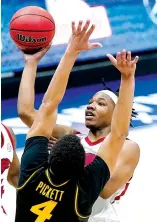  ?? Associated Press ?? ■ Arkansas' JD Notae shoots against Missouri's Javon Pickett on Friday during the first half of the Southeaste­rn Conference Tournament in Nashville, Tenn.