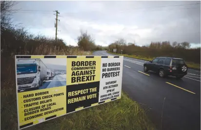  ?? (Clodagh Kilcoyne/Reuters) ?? A SIGN from Border Communitie­s Against Brexit is seen last week on the borderline between County Cavan in Ireland and County Fermanagh in Northern Ireland.