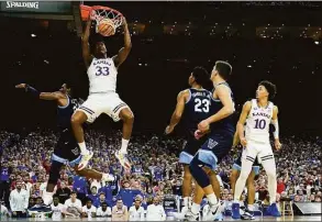  ?? Brynn Anderson / Associated Press ?? Kansas’ David McCormack (33) dunks the ball against Villanova during the second half at the men’s Final Four Saturday in New Orleans.