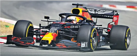  ??  ?? Main challenger: Max Verstappen during practice (above) and in the paddock (below) in Barcelona where he aims to follow up last weekend’s win with a fresh victory