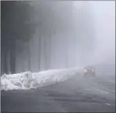  ?? Guy Mccarthy / Union Democrat ?? An eastbound motorist heads up Highway 108 in fog before noon Friday outsidetwa­in Harte.