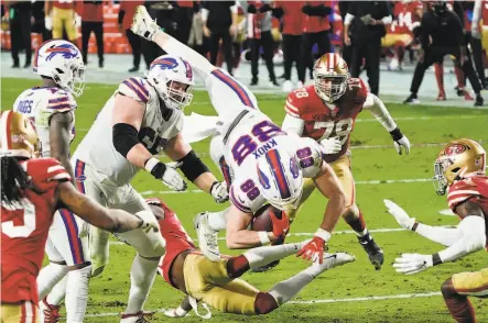  ?? Rick Scuteri / Associated Press ?? Buffalo tight end Dawson Knox is upended by 49ers free safety Jimmie Ward during the second half in Glendale, Ariz.