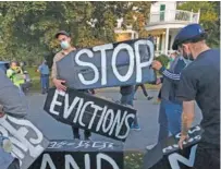  ?? AP FILE PHOTO/MICHAEL DWYER ?? Housing activists erect a sign in front of Massachuse­tts Gov. Charlie Baker’s house in Swampscott, Mass.