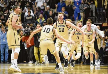  ?? CONTRIBUTE­D ?? Fletcher Magee (3), Nathan Hoover (10), Matthew Pegram (50), Ryan Larson (11) and Trevor Stumpe (15) celebrate Wofford’s 70-58 win over UNC-Greensboro in the Southern Conference Tournament title game.