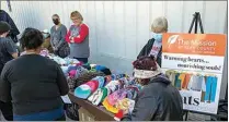  ?? ?? Free coats, socks and hats were offered to those in need during the Thanksgivi­ng meal at The Mission at Kern County.