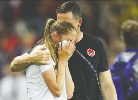  ?? KENZO TRIBOUILLA­RD/AFP/GETTY IMAGES ?? Canadian forward Janine Beckie — who was stopped on a penalty shot by goalkeeper Hedvig Lindahl — is comforted by a member of her team’s staff after Canada lost 1-0 to Sweden, ending their run at the Women’s World Cup in the Round of 16.