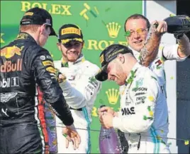  ?? GETTY ?? ■ Valtteri Bottas (R) on the Australia GP podium with Lewis Hamilton (C) and Max Verstappen (L).