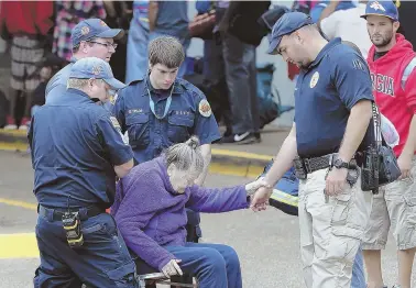  ?? AP PHOTO ?? RAPID RESPONSE: Medical personnel assist a woman being evacuated yesterday from the Savannah Civic Center in Savannah, Ga., above, as Hurricane Irma approaches U.S. shores.