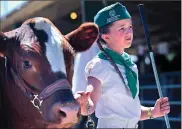  ??  ?? Chantry Brackett, 11, with Colusa 4-H, walks her steer, Fuzz, on Saturday at the Colusa Country Fairground­s in Colusa.