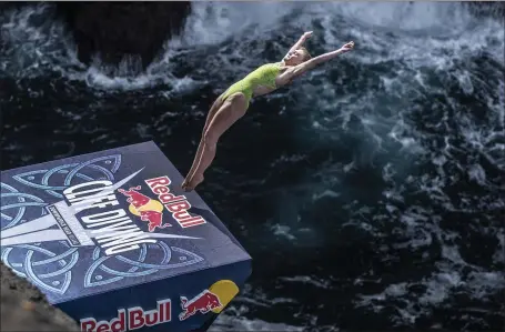  ?? ROMINA AMATO — RED BULL CONTENT POOL ?? INTO THE WAVES: Eleanor Smart dives off Downpatric­k Head in Ireland during last year’s Red Bull Cliff Diving World Series.