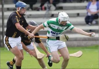  ??  ?? Harry Goff of Shamrocks comes under pressure from Adamstown’s Brendan Furlong.