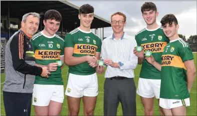  ?? (fourth from left) Photo by Michelle Cooper Galvin ?? Stephen Cotter presenting Mouth Guards to Kerry Minor Captain Paul O’Shea for the Kerry minor team with Peter Keane Kerry Minor Manager, Daragh Rahilly, David Mangan and Owen Fitzgerald at Fitzgerald Stadium, Killarney on Friday.