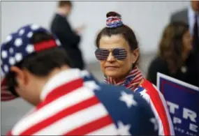  ?? THE ASSOCIATED PRESS ?? Donna Cancassi, a supporter of Republican presidenti­al candidate Donald Trump, wears an outfit emblazoned with stars and stripes as she waits in line to hear a speech by Melania Trump in Berwyn Thursday.