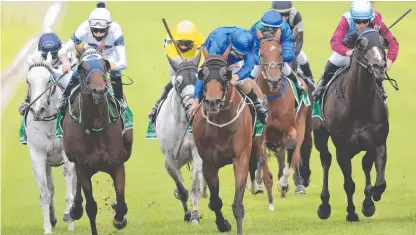  ??  ?? Robbie Dolan on Spirit Ridge (black pom pom) wins race 6 at Royal Randwick in Sydney, Picture: Getty Images