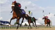  ?? MARK BLINCH/THE CANADIAN PRESS ?? Luis Contreras, aboard Holy Helena, left, crosses the line to win the 158th running of the Queen’s Plate on Sunday at Woodbine Racetrack.