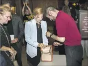  ??  ?? AMY ADAMS is just another theatergoe­r as her purse is searched before entering the theater.