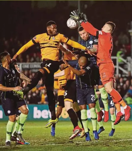  ?? REUTERS PIC ?? Newport’s Jamille Matt (second from left) vies for the ball with Manchester City goalkeeper Ederson at Rodney Parade on Saturday.