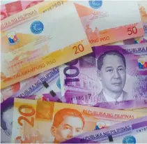  ??  ?? THE PESO strengthen­ed further as investors cheered the tax plan’s enactment.