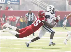  ?? Gary Kazanjian / Associated Press ?? UConn wide receiver Cameron Ross, right, runs past Fresno State defensive back Emari Pait during the first half Saturday in Fresno, Calif.