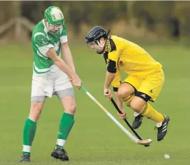  ?? Photograph: Neil Paterson. ?? Jump to it: Inveraray’s Nicholas Crawford avoids the swing of Beauly’s Colin Macdonald.