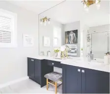  ??  ?? Dual sinks flank a makeup desk in the spacious master ensuite.