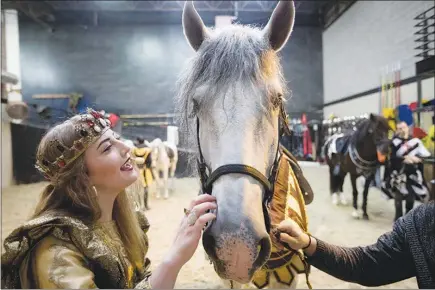  ?? PHOTOS BY ALLISON V. SMITH / THE NEW YORK TIMES ?? Monet Lerner talks to her horse Jan. 21 at the Medieval Times in Dallas. The dinner theater chain has changed its plot, in which a king fought off a challenger, to one where a queen, in this case, Lerner, presides over a tourney and rebukes a sexist...