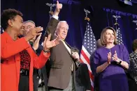  ?? AP Photo/Jacquelyn Martin ?? ■ House Minority Leader Nancy Pelosi of Calif., right, steps away from the podium as House Minority Whip Steny Hoyer, D-Md., makes the thumbs up sign, after Pelosi spoke about Democratic gains in the House of Representa­tives to a crowd of Democratic supporters during an election night returns event Tuesday at the Hyatt Regency Hotel in Washington. At far left is Rep. Barbara Lee, D-Calif., with Rep. G.K. Butterfiel­d, D-N.C., chairman of the Congressio­nal Black Caucus.