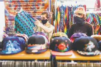  ?? Gabrielle Lurie / The Chronicle ?? Cody Dalton ( left) and Will Pamula shop at Love on Haight Street in San Francisco.