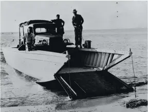  ??  ?? Here is the first production version of the full-ramp Higgins boat, the LCV. Note the coxswain’s station is aft on the rear deck, versus low besides the engine in the LCVP. Though the LCV had been replaced with the LCVP when this picture was taken in 1943, they were still in use. Most likely, the first time these boats went in for major repairs, they were updated to LCVP configurat­ion.