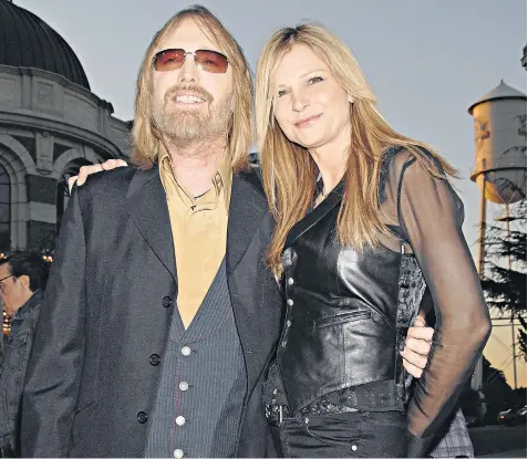  ??  ?? Tom Petty pictured with his wife Dana in 2007. Left, his daughters Adria and Annakim