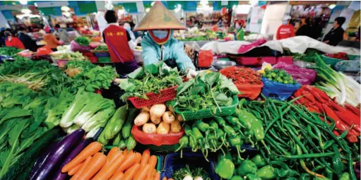  ??  ?? January 31, 2020: A vegetable market in Haikou, Hainan Province. During the novel coronaviru­s epidemic, the Chinese government has adopted various measures to guarantee the supply of daily necessitie­s and maintain price stability. by Guo Cheng/xinhua