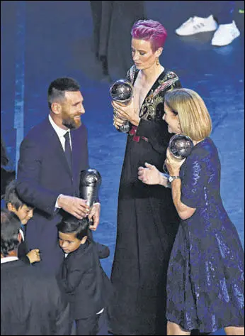  ?? REUTERS ?? Lionel Messi is congratula­ted by USA women's coach Jill Ellis (right) as the FIFA Women's Player of the Year award winner Megan Rapinoe of the US looks on, in Milan on Monday.