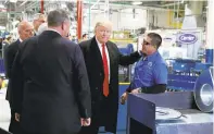  ?? EVAN VUCCI/ASSOCIATED PRESS PHOTOS ?? Trump talks with workers at the Carrier factory on Thursday.