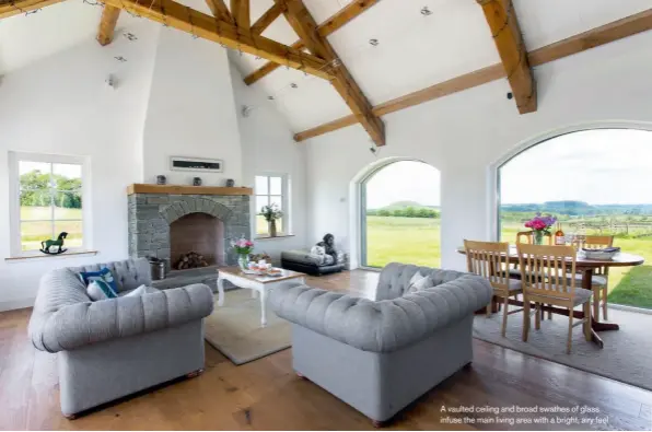  ??  ?? A vaulted ceiling and broad swathes of glass infuse the main living area with a bright, airy feel