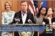  ?? CT-N screen shot ?? As Gov. Ned Lamont signed the state’t two-year budget on June 23, he was joined by Republican state Rep. Holly Cheeseman of East Lyme, left, the ranking GOP member of the legislatur­e's finance committee. That punctuated the fact that about half of all Republican­s in the General Assembly voted for the budget, a triumph for Lamont, a Democrat. At right are Melissa McCaw, Lamont’s budget chief, and Lt. Gov. Susan Bysiewicz.