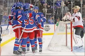  ?? Bruce Bennett / Getty Images ?? The Rangers celebrate a second period goal by Chris Kreider against Anton Forsberg (31) of the Senators at Madison Square Garden Saturday.