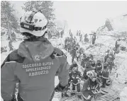  ?? National Alpine Cliff and Cave Rescue Corps via Associated Press ?? Rescuers on Saturday search the site where an avalanche engulfed the Hotel Rigopiano in central Italy on Wednesday. At least five people were killed.