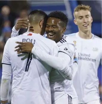  ?? AP ?? PLENTY TO CELEBRATE: Wilfrid Kaptoum, center, congratula­tes Gustavo Bou after scoring in the 86th minute in the Revs’ 4-1 win over CF Montreal on Wednesday night.