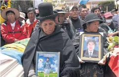  ?? REUTERS ?? People hold photograph­s of two men who died in violent clashes earlier this week, in Juliaca, Peru.