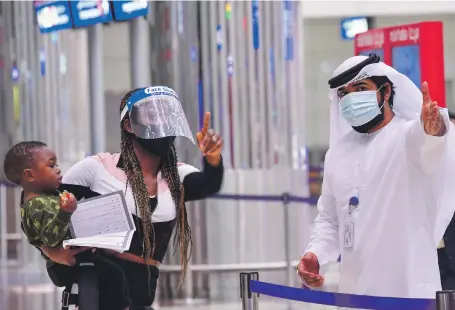  ?? AFP ?? A tourist receives instructio­ns at Dubai airport on Wednesday after the UAE reopened its doors to internatio­nal visitors