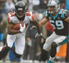  ?? Bob Leverone /AP ?? Atlanta Falcons’ Roddy White (84) runs after catching a pass as Carolina Panthers’ Luke Kuechly (59) pursues in the first half of an NFL football game in Charlotte, N.C., Sunday, Nov. 16, 2014.