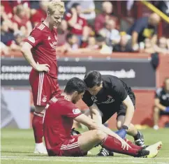  ??  ?? 0 Scott Mckenna gets treatment on a suspected hamstring injury.