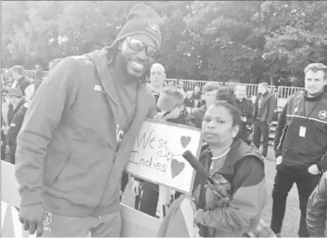  ?? CWI Media) (Photo courtesy ?? Superstar opener Chris Gayle poses with a fan during the abandoned ODI against Ireland.