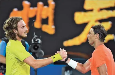  ??  ?? Greece’s Stefanos Tsitsipas (left) and Spain’s Rafael Nadal greet each other after their men’s singles quarter-final match on day 10 of the Australian Open tennis tournament yesterday. — AFP