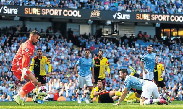  ?? Picture: Chloe Knott - Danehouse/Getty Images ?? Bernardo Silva of Manchester City scores during the Premier League match between Manchester City and Watford at Etihad Stadium in Manchester yesterday.